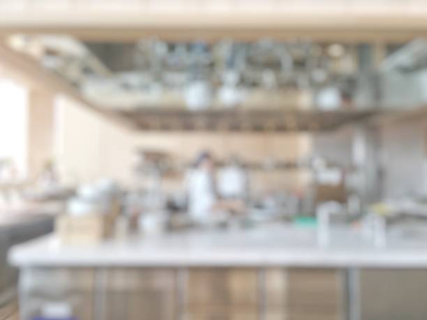 istock Open kitchen blur background in luxury hotel restaurant facility showing chef cooking over blurry food counter for buffet catering service 1025682512