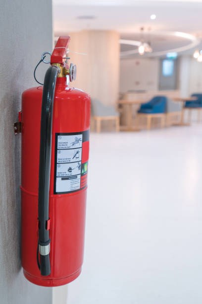 istock Fire extinguisher on wall in front of room at building 1025684798