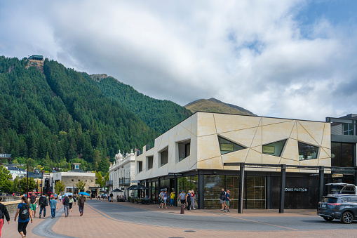 Queenstown, New Zealand - January 17, 2018: Modern building with mountain and forrest in the back