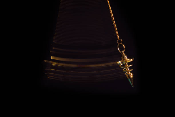 Hypnotism pendulum swinging with motion blur Pendulum used for hypnotism and readings swinging with motion blur pendulum stock pictures, royalty-free photos & images