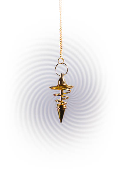 Pendulum used for hypnotism and readings on a swirl background