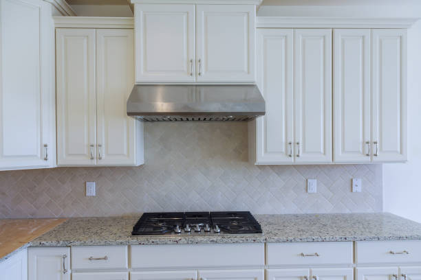 istock Empty tiled kitchen with dish stainless steel appliances 1025723350