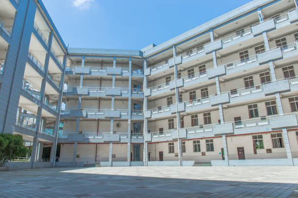 istock Modern school building on the university campus, surrounded by floors, with a square in the middle, sunny in summer 1025728372