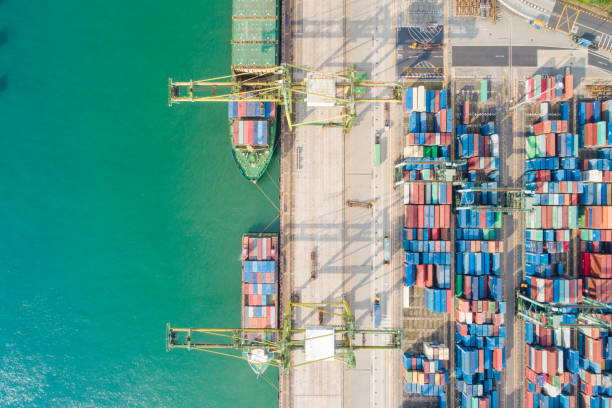 istock Container Cargo freight ship with working crane bridge in shipyard in singapore 1025733512