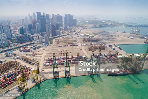 istock Container Cargo freight ship with working crane bridge in shipyard in singapore 1025734000