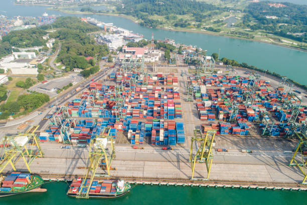 istock Container Cargo freight ship with working crane bridge in shipyard in singapore 1025734018