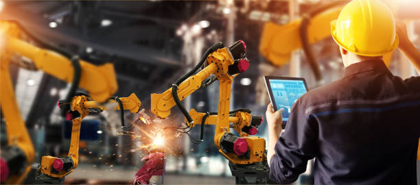 Engineer check and control welding robotics automatic arms machine in intelligent factory automotive industrial with monitoring system software. Digital manufacturing operation. Industry 4.0 Engineer check and control welding robotics automatic arms machine in intelligent factory automotive industrial with monitoring system software. Digital manufacturing operation. Industry 4.0 robotic arm photos stock pictures, royalty-free photos & images