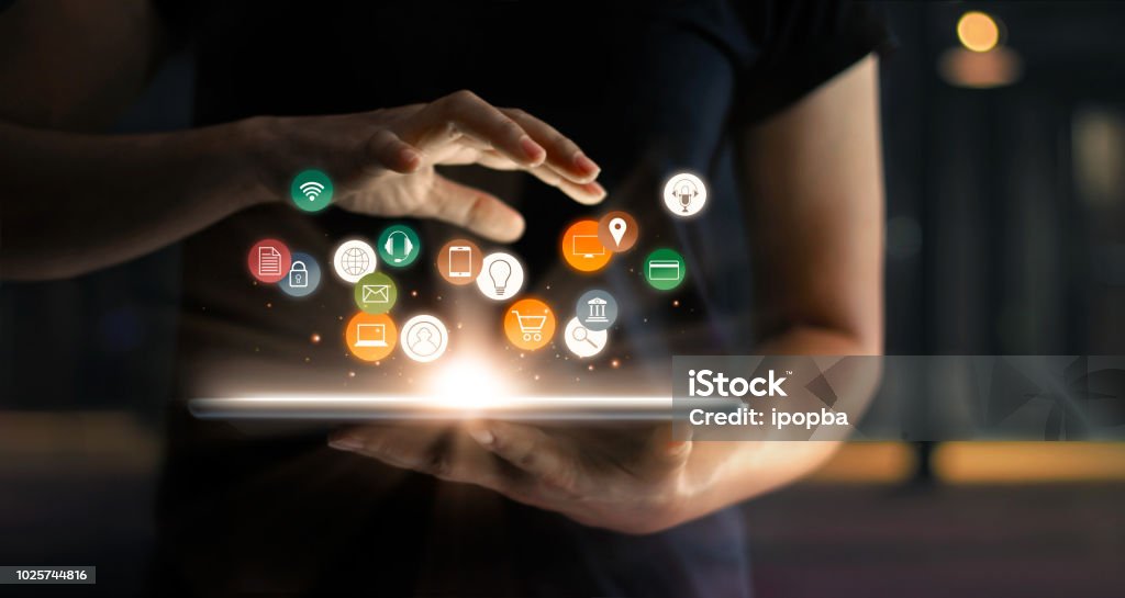 Digital online marketing commerce sale concept. Woman using tablet payments online shopping and icon customer network connection on hologram virtual screen, m-banking and omni channel. Technology Stock Photo