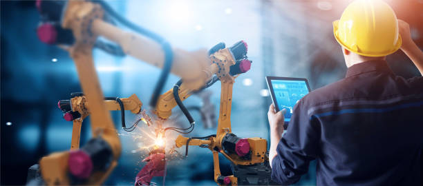 istock Engineer check and control welding robotics automatic arms machine in intelligent factory automotive industrial with monitoring system software. Digital manufacturing operation. Industry 4.0 1025745022