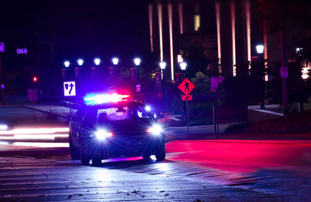 Night Shift The officer races through the night police car photos stock pictures, royalty-free photos & images