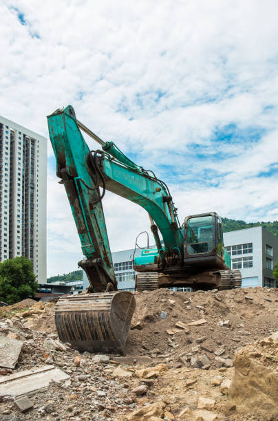 istock A large excavator is digging and carrying the collapsed building ruins at the construction site of the site. 1025767754