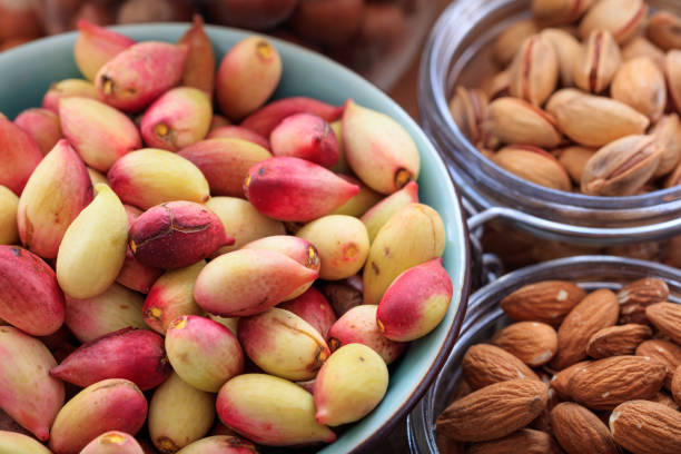 Fresh pistachios in shell in a ceramic pot