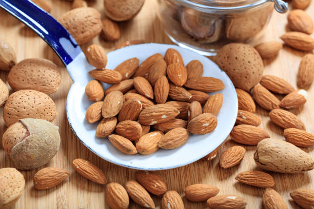 istock Almonds and an old ladle on a wooden table 1025774094