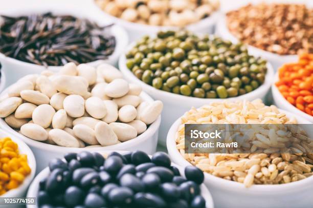 Various Raw Legumes And Rice In Bowls Stock Photo - Download Image Now - Bean, Legume Family, Cereal Plant