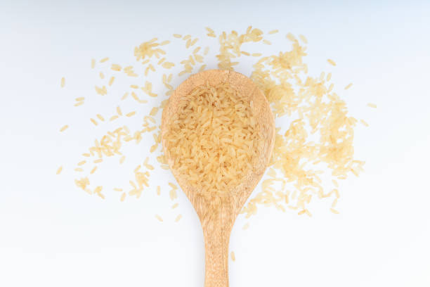 istock Raw parboiled rice in a wooden spoon 1025781610