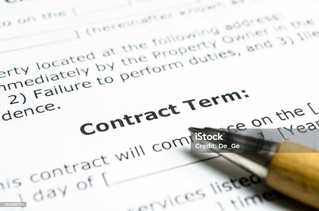 Contract term with wooden pen Contract Stock Photo