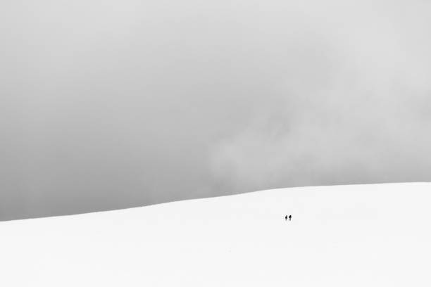 istock A very minimalistic view of two distant people over a mountain covered by snow 1025817916