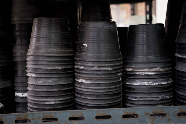 old black plastic plant pot on shelf