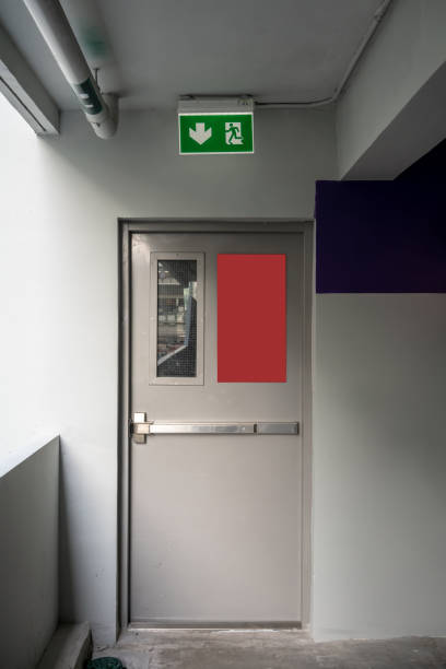 istock Fire exit emergency door grey color metal material and concrete floor and white wall in building. 1025839564