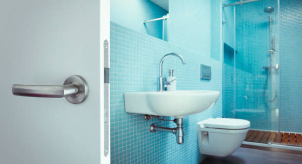 Modern bathroom interior in blue color with closet, shower and washbasin