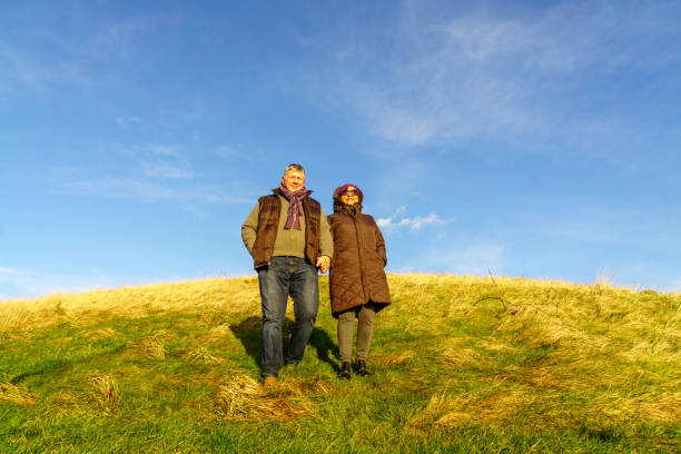 istock Senior couple walking on countryside path in winter 1025847668