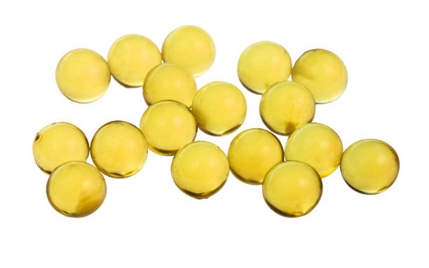 istock yellow capsules with oil isolated on white 1025848292