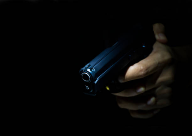 male hand showing gesture Close up male hand showing gesture try to kill someone with gun, Gunman with dark background gunman photos stock pictures, royalty-free photos & images