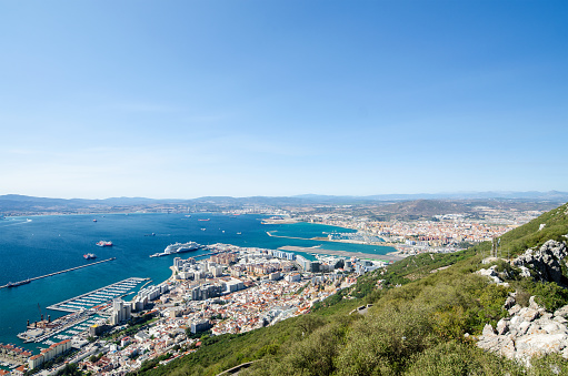 GIBRALTAR/BRITISH OVERSEAS TERRITORY OF GIBRALTAR - SEPTEMBER 18: Overall view from top of the Rock of Gibraltar city, cruise port and marina, airport runway, Gibraltar Bay or Bay of Algeciras and the spanish town and port of La Linea de la Concepcion. Gibraltar city, British overseas territory of Gibraltar on September, 18, 2017