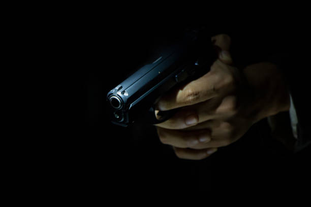 istock male hand holding gun 1025857822