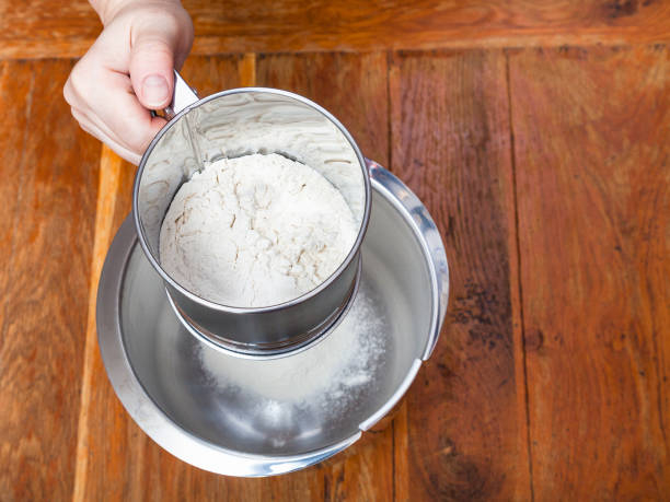 istock sifting the flour through sifter into steel bowl 1025858404