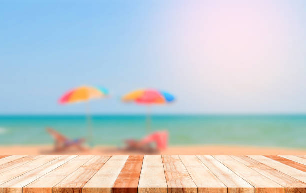 istock wooden plank with blurred beach background 1025858518