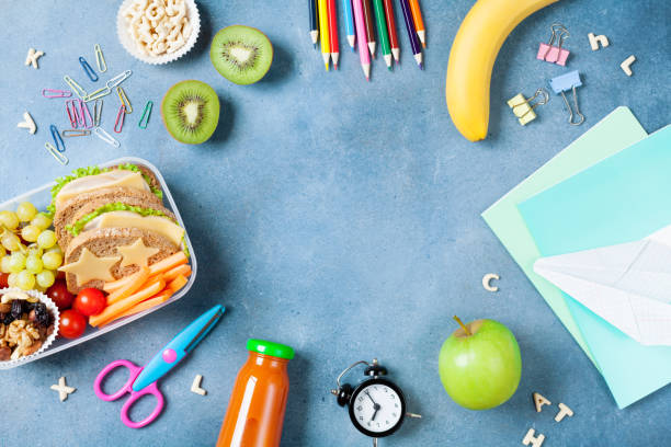 istock Back to school concept. Healthy lunch box and colorful stationery top view. 1025866310