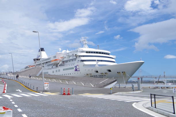 Yokohama, Japan - August 15, 2018: It is a Ōsanbashi Pier of Yokohama Port. A big luxury liner is anchored.The name of the ship is ’Pacific Venus’. She sails under Japanese colours.This pier is called \