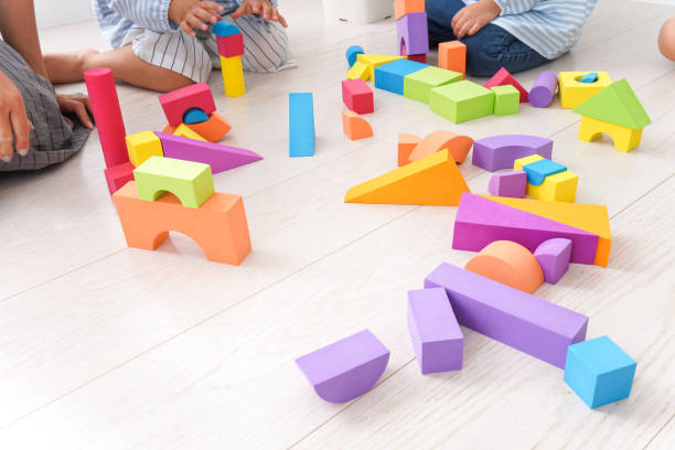 istock Children  and teacher playing with toy 1025873080