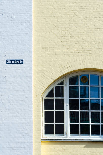 Old beautiful window on a yellow wall. Architecture. Backgrounds. Travels