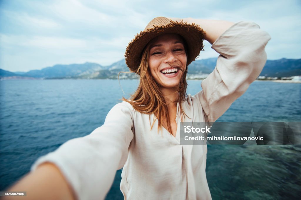 Selfie Young woman doing selfie on a vacation Women Stock Photo