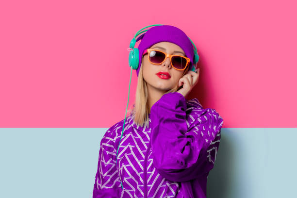 Young blonde girl in 90s sports jacket and hat stock photo