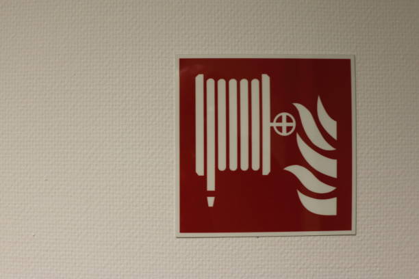 istock safety sign for a fire hose 1025885304