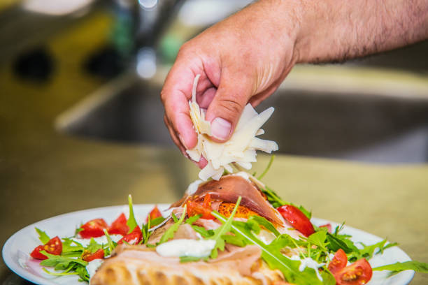 istock The chef in the kitchen prepares pizza 1025885328