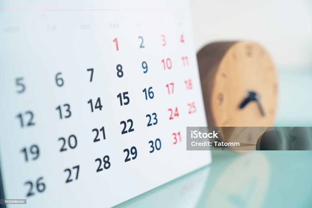 close up of calendar and clock on the table, planning for business meeting or travel planning concept Calendar Stock Photo