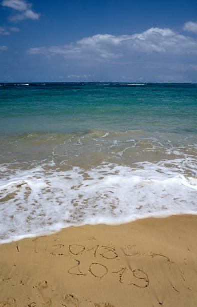 istock 2019 and 2018 year on the sand beach 1025891086