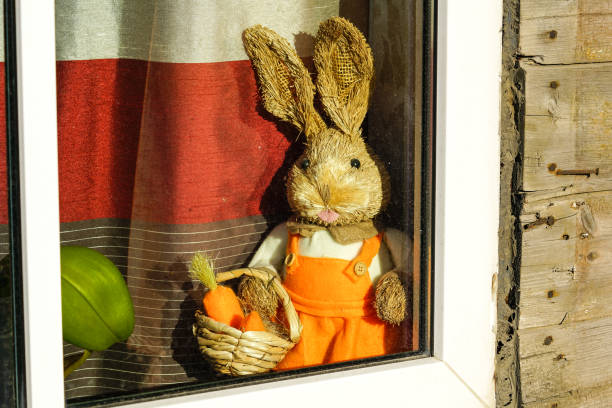 toy bunny with carrot basket on the windowsill, poor view