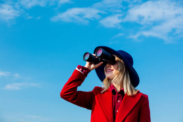 istock Young girl in coat with binoculars 1025907184