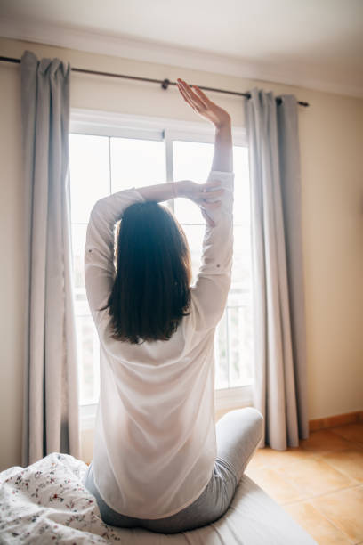 istock Pretty woman stretching in bed after wake up 1025907582