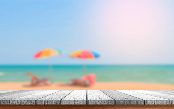 istock wooden plank with blurred beach background 1025907816