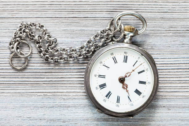 istock retro pocket watch with chain on gray table 1025907916