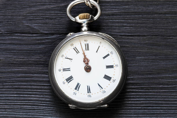 istock two minutes to twelve on vintage watch on black 1025908054