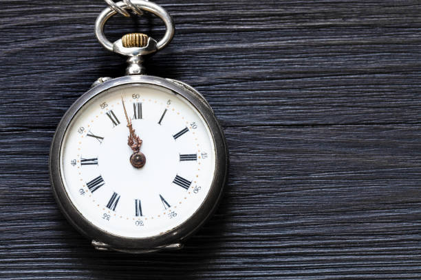 istock two minutes to twelve on antique watch on black 1025911626