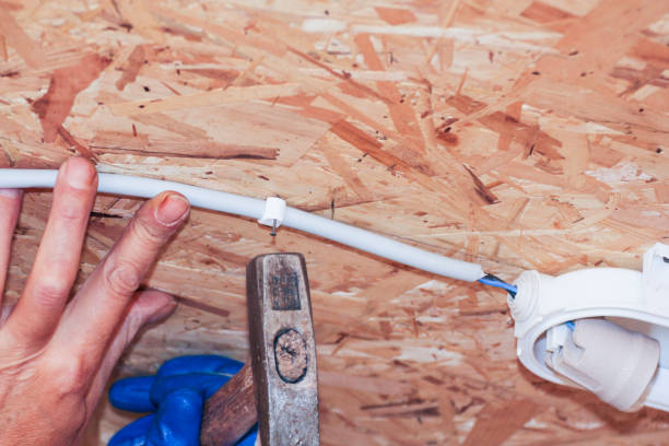 istock Fastening the cable with a plastic clip on the ceiling. 1025915586
