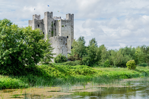 Trim, Ireland - August 18, 2018:  Trim Castle, sited by the banks of the River Boyne, County Meath.  Trim Castle, the largest Anglo-Norman castle in Ireland, was constructed over a thirty-year period dating from 1176 by Hugh de Lacy and his son Walter. Hugh de Lacy was granted the Liberty of Meath by King Henry II in 1172.  The castle is now in state ownership and operated by the Ministry of Public Works.  It was used as a filming location for 'Braveheart' (1995), a movie directed by Mel Gibson.
